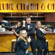James Bond poses with bar staff