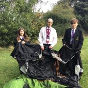 Baxter College teacher Andrew Macpherson and Year 9 students Aylah Jones and Ryan Annetts sorting out one of their few old tents