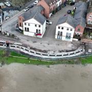 Drone camera shows work to install permanent flood barriers progressing