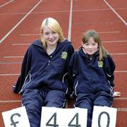 Cashback: Athletes Laura and Hannah Baldwin show the amount the athletic club handed to the Ray Mercer Sporting Foundation  and which has now been donated to the appeal.