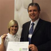 Jessica receives her award from College Principal Andrew Miler