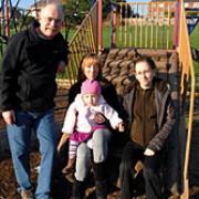 Positive energy: John Gordon of Community Action Newtown, with member Vanessa Hughes, holding niece Courtney White, 1, and Courtney's mother Melissa Perkins, in the Manor Road  play area.