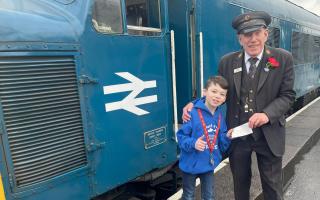 Young fundraiser Jacob Holden with Kidderminster station master Geoff Smith
