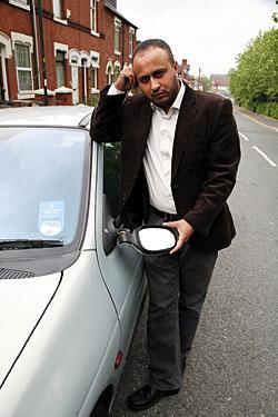 Alerted police: Councillor Mumshad Ahmed with one of the damaged cars.